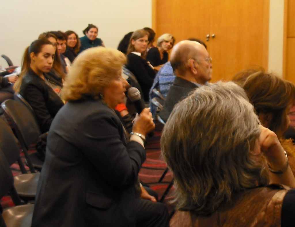 La señora mientras hacía la famosa pregunta; sentado delante de ella el anciano del bastón